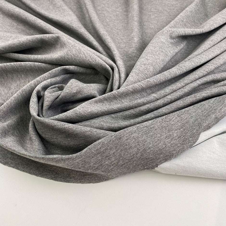 Grey melange polyester stitch milano jersey. High quality deadstock fabric.