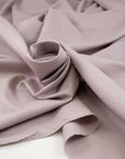 Soft cotton jacquard fabric in pale purple. High quality deadstock fabric.