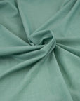 Irregular soft yarn green dyed cotton. High-quality deadstock fabric collected in Stock from a Maison de Couture in Italy.