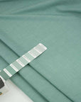 Irregular soft yarn green dyed cotton. High-quality deadstock fabric collected in Stock from a Maison de Couture in Italy.