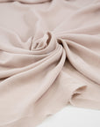 Beige and semi-trasparent polyester crepe cady. High quality deadstock fabric.