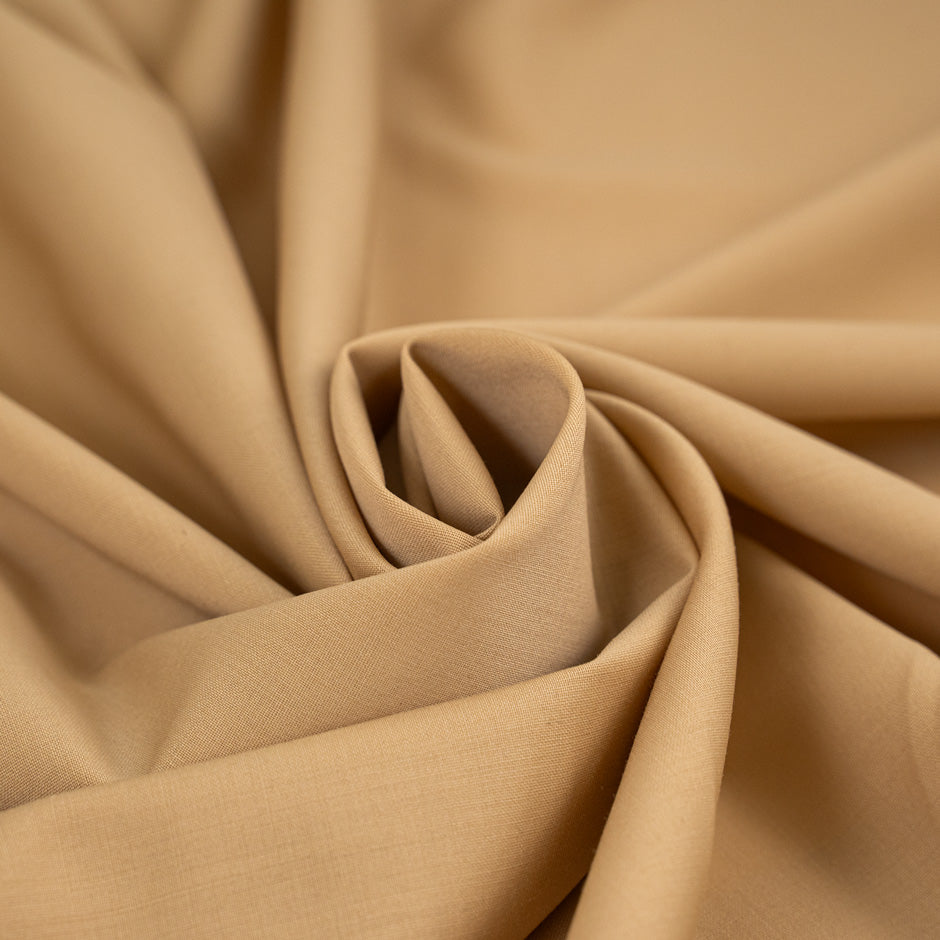 Wool and polyester elasticized camel color soft fabric. High-quality deadstock collected in Stock from a Maison de Couture in Italy.