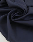 Pure virgin wool in dark blue with a subtle textured micro square design. Very soft, light, and not transparent. Ideal for shirting, dresses, and lightweight garments. High-quality deadstock collected in Stock from a Maison de Couture in Italy.