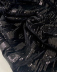 Stretch polyester chenille with shiny paillettes and geometric design soft light and fluid ideal for bold eveningwear. High-quality deadstock collected in Stock from a Maison de Couture in Italy.