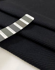 Black mesh fabric in a blend of cotton, polyester, and elastane with a textured surface, soft, breathable, and slightly stretchy. Ideal for inserts, layering, and sporty pieces. High-quality deadstock collected in Stock from a Maison de Couture in Italy.