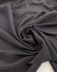 Black-colored soft silk crepe georgette. High quality deadstock fabric collected in Stock from a Maison de Couture in Italy.