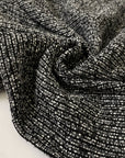 Tweed in polyester wool and viscose blend in smoked pearl grey. Very soft, light, warm and flowy. Ideal for winter dresses, jackets, skirts and light coats. High-quality deadstock collected in Stock from a Maison de Couture in Italy.