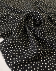 Pure silk crêpe de chine, very soft and light, with a black and white polka dot print. Not transparent and very flowy. Ideal for shirting, dresses, and skirts. High-quality deadstock collected in Stock from a Maison de Couture in Italy.