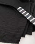Jacquard stripe of wool-polyester blend, soft and falling black color. High quality deadstock fabric collected in Stock from a Maison de Couture in Italy.