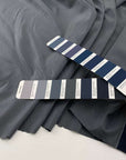 Blue-colored cotton fabric and soft, stretch polyamide membrane with storm system. High quality deadstock fabric.