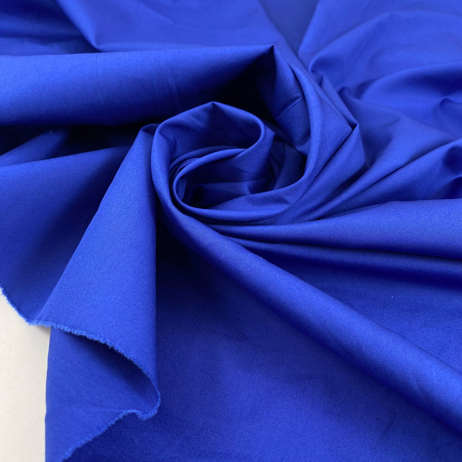 Pure cotton poplin in bright blue, very soft and not transparent, ideal for shirts, dresses, and casual garments. High-quality deadstock collected in Stock from a Maison de Couture in Italy.