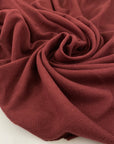 Pure cotton jersey pique, stretch in burgundy color very soft, light and flowy. High-quality deadstock fabric by the meter collected in Stock from a Maison de Couture in Italy.