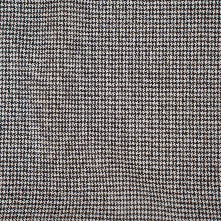Square pattern in black and white wool and nylon fabric. It is stretch and falling. High-quality deadstock fabric collected in Stock from a Maison de Couture in Italy.