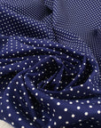 Pure cotton stretch fabric with a blue base and white polka dot design, very soft, medium weight, and not transparent. Ideal for shirts, dresses, and skirts. High-quality deadstock collected in Stock from a Maison de Couture in Italy.