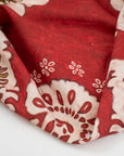 Red-based and printed linen and cotton. The fabric has a floral and structured design. High-quality deadstock fabric collected in Stock from a Maison de Couture in Italy.