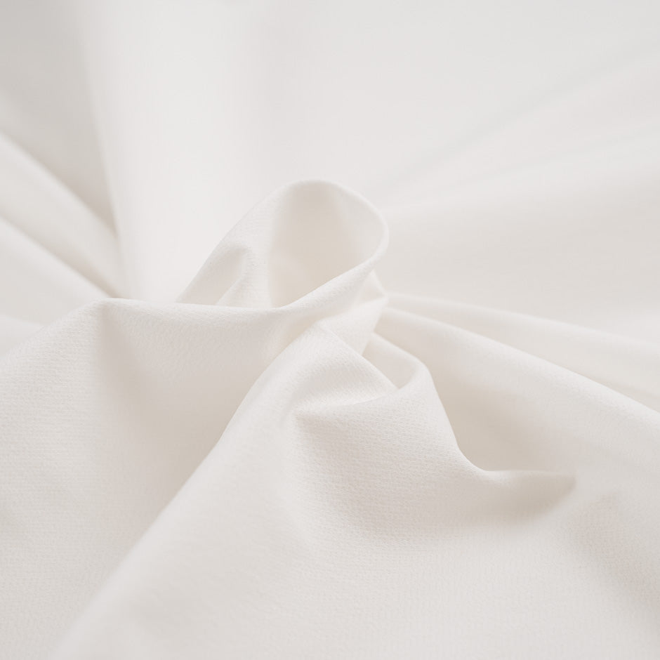 White and stretch technical polyester. High-quality deadstock fabric collected in Stock from a Maison de Couture in Italy.