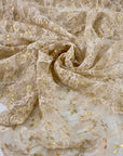 Polyester lace in floral design stretch, very soft and light. Skin ground color with some gold lurex. High-quality deadstock fabric collected in Stock from a Maison de Couture in Italy.