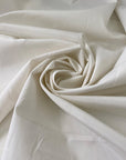 Cotton, polyester and elastane blend in white Marshmallow. Soft, not transparent, with a subtle micro texture. Ideal for trousers, dresses and skirts. High-quality deadstock collected in Stock from a Maison de Couture in Italy.