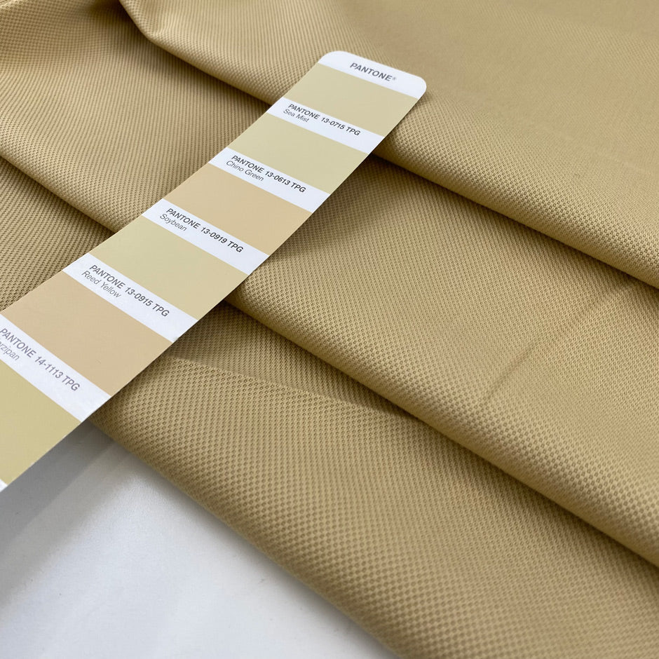 Stretch cotton piqué in very light camel color, with structured textured and very soft. High-quality deadstock fabric by the meter collected in Stock from a Maison de Couture in Italy.