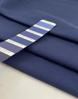 Pure cotton fabric in blue, very thick and stiff with a dry handfeel, ideal for structured garments, jackets, and utility pieces. High-quality deadstock collected in Stock from a Maison de Couture in Italy.