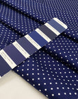 Pure cotton stretch fabric with a blue base and white polka dot design, very soft, medium weight, and not transparent. Ideal for shirts, dresses, and skirts. High-quality deadstock collected in Stock from a Maison de Couture in Italy.