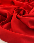Red heavy cotton jersey with a textured surface, slight stretch, and soft, flowy drape. High-quality deadstock collected in Stock from a Maison de Couture in Italy.