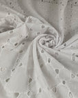 White cotton Sangallo lace with delicate embroidered eyelets and soft, breathable texture ideal for blouses dresses and summerwear. High-quality deadstock collected in Stock from a Maison de Couture in Italy.