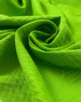 Pure cotton jacquard in green color reference Jasmine Green. Very soft and flowy, not transparent. Ideal for dresses, skirts, trousers, and jackets. High-quality deadstock collected in Stock from a Maison de Couture in Italy.