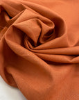 Cotton and linen blend in orange color reference Sunbaked, very soft and not transparent. Ideal for trousers, skirts, dresses, and light summer jackets. High-quality deadstock collected in Stock from a Maison de Couture in Italy.