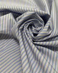 Soft and lightweight pure cotton poplin with stripes in light blue, white, and ochre. Not transparent, perfect for shirting and dresses.High-quality deadstock collected in Stock from a Maison de Couture in Italy.
