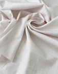 Pure cotton shirting fabric with a white ground and pale pink stripe. Very soft, light, and not transparent. Ideal for shirting and dresses. High-quality deadstock collected in Stock from a Maison de Couture in Italy.