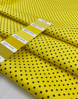 Pure cotton light gabardine with very bright yellow ground and black polka dots design. very soft medium weight. Ideal for dresses, skirts and shirts.High-quality deadstock collected in Stock from a Maison de Couture in Italy.