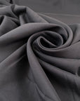 Stretch and falling dark gray silk crepe de chine. High-quality deadstock fabric collected in Stock from a Maison de Couture in Italy.