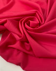 Fluorescent fuchsia polyester crêpe de chine with a fluid drape and matte texture ideal for bold blouses dresses and linings. High-quality deadstock collected in Stock from a Maison de Couture in Italy.