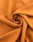 Dark yellow viscose cady crepe fabric with a soft hand, non-stretch constructionand not transparent. Ideal for creating trousers. High-quality deadstock collected in Stock from a Maison de Couture in Italy.