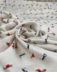 Very soft and light polyester satin with ivory ground and small fantasy design of birds and lighthouses. Not transparent. High-quality deadstock collected in Stock from a Maison de Couture in Italy.