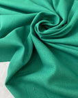 Viscose and elastane stretch Punto Milano jersey in green color reference Rolling Hills. Very soft and flowy, slightly heavy, ideal for trousers, skirts, jackets, and dresses. High-quality deadstock collected in Stock from a Maison de Couture in Italy.