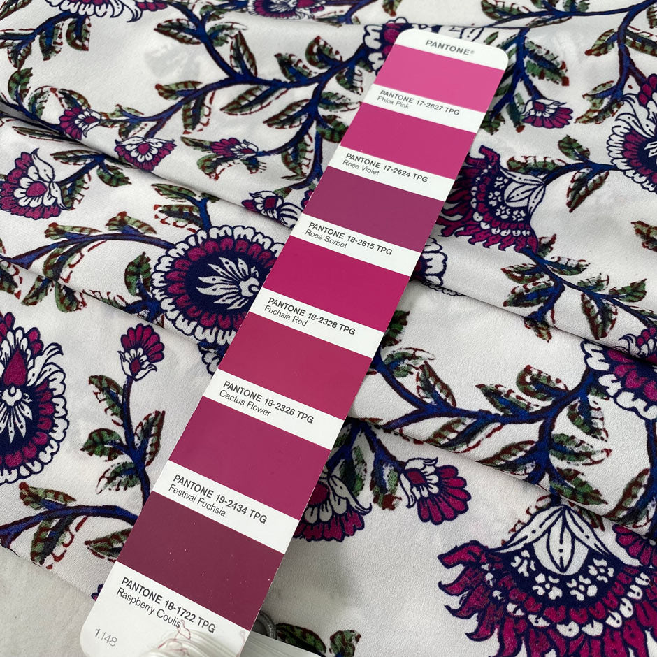 Pure silk crêpe de chine with a white ground and floral design in the shades of festival fuchsia, blue, and green. Very soft and flowy, not transparent. Ideal for dresses, skirts, blouses, and shirting. High-quality deadstock collected in Stock from a Maison de Couture in Italy.