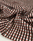 Soft cotton gabardine with elastane checked design. Multicolor in the shades of pink, white and dark brown. High-quality deadstock fabric by the meter collected in Stock from a Maison de Couture in Italy.