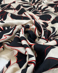 Pure viscose, very soft and light, with beige ground and flower printing in red and black shades. High-quality deadstock fabric by the meter collected in Stock from a Maison de Couture in Italy.