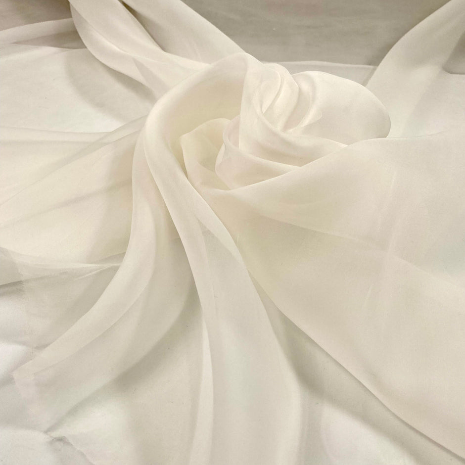 Very light pure white silk organza. It is very soft, flowing and transparent. High-quality deadstock fabric collected in Stock from a Maison de Couture in Italy.