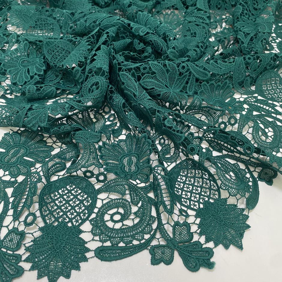 Light and soft polyester macro lace in dark green with a double scallop edge and baroque floral design. Perfect for dresses, skirts, and blouses.High-quality deadstock collected in Stock from a Maison de Couture in Italy.