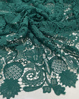Light and soft polyester macro lace in dark green with a double scallop edge and baroque floral design. Perfect for dresses, skirts, and blouses.High-quality deadstock collected in Stock from a Maison de Couture in Italy.