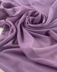 Stretch microtulle in regal orchid. Very light, transparent, flowy and soft – ideal for dresses, underwear, and t-shirts. High-quality deadstock collected in Stock from a Maison de Couture in Italy.