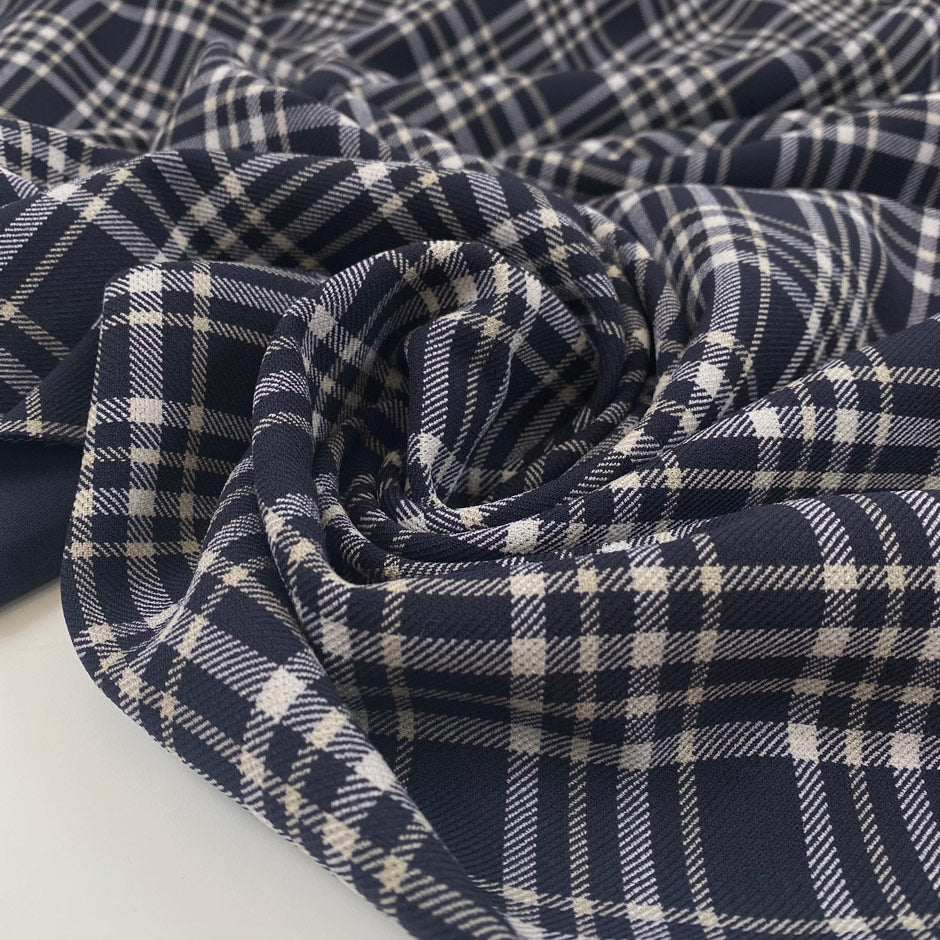 Polyester and viscose cady with elastane. Scottish pattern in the shades of dark blue and white. Very soft, double face. High-quality deadstock collected in Stock from a Maison de Couture in Italy.