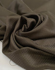 Polyester jacquard in dark brown with an ultra-small pattern, very soft, light, and slightly shiny, ideal for dresses, shirts, and fluid tailoring. High-quality deadstock collected in Stock from a Maison de Couture in Italy.
