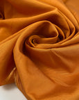 Pure viscose in apricot orange very soft, light, and flowy. High-quality deadstock fabric by the meter collected in Stock from a Maison de Couture in Italy.