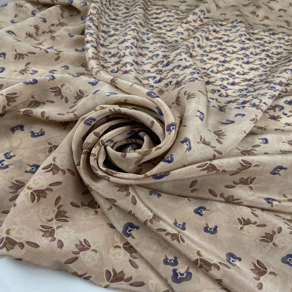 Pure silk crepe de chine in ivory cream ground, with very little floral design in blue and purple shades. Very flowy, light and ideal for shirts, blouses, skirts, and dresses. High-quality deadstock fabric by the meter collected in Stock from a Maison de Couture in Italy.