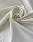 Stretch cotton piquet with texture in white color reference Sugar Swizzle. Very soft with low stretch. Ideal for trousers, dresses, skirts and jackets. High-quality deadstock collected in Stock from a Maison de Couture in Italy.