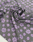 Mixed polyester and wool with pied de poule in black and white and flower design in lilac. Very soft and light, warm. Ideal for dresses, trousers, skirts and jackets.High-quality deadstock collected in Stock from a Maison de Couture in Italy.